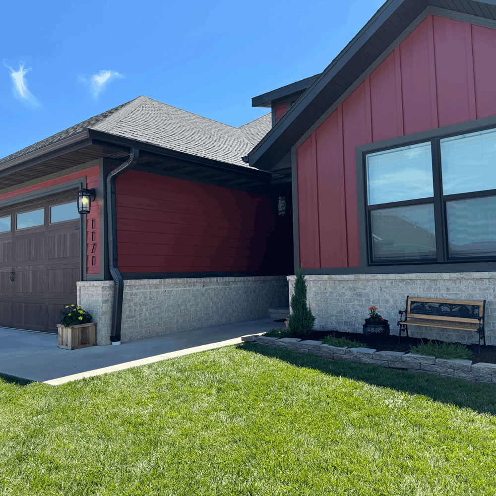 Crew painting weathered Springfield home exterior with ladders, masked windows, and protected landscaping